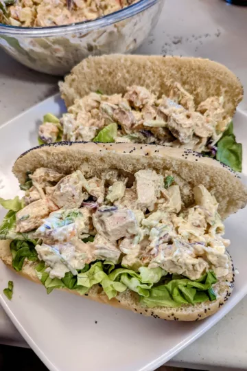 chicken salad on a poppyseed bun with lettuce