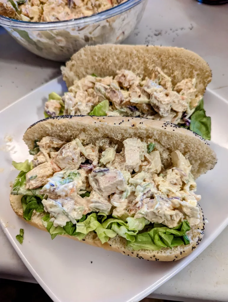 chicken salad on a poppyseed bun with lettuce