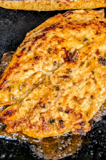 A chipotle marinated chicken breast on a griddle.