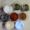 Clear containers of spices to make creole seasoning.