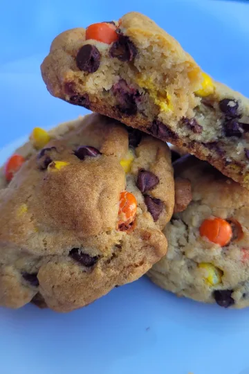 Two Reese's Pieces cookies with half a cookie lying on top.