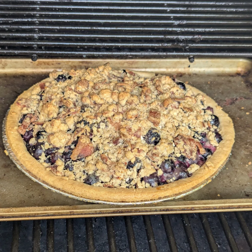 A Smoked Bacon Crumble Blueberry Pie on the smoker.