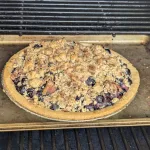 A bacon crumble blueberry pie on the smoker.