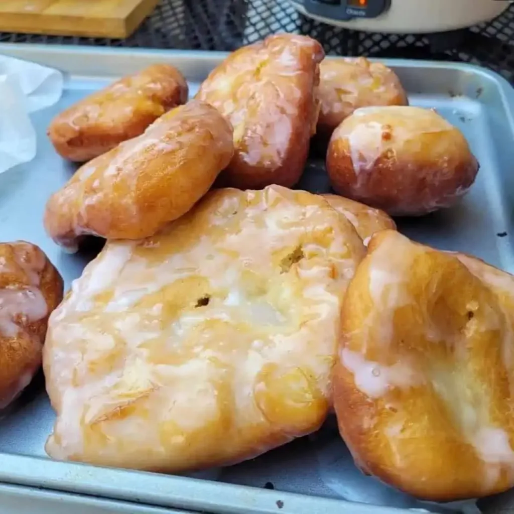 A tray filled with homemade apple fritters.