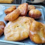 A tray filled with homemade apple fritters.