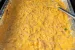 Beer cheese queso in a tin pan on the BBQ.