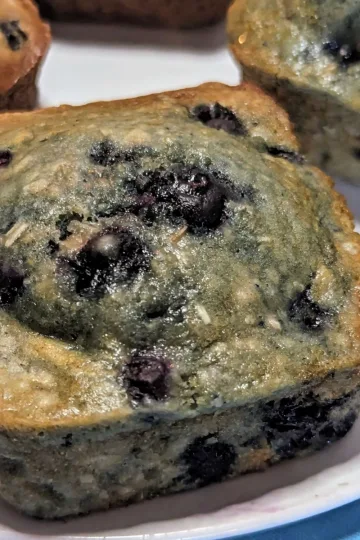 Blueberry oatmeal muffins on a plate.