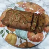 A loaf of Pumpkin Chocolate chip bread on a plate.