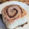 A cinnamon bun on a plate.