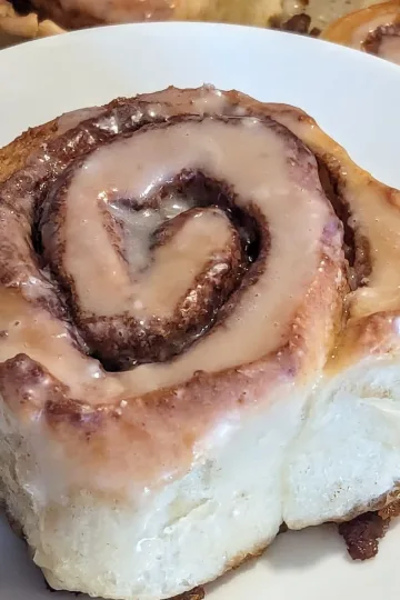 A cinnamon bun on a plate.