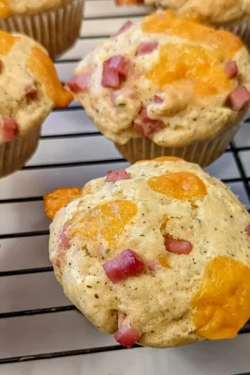 Ham and cheese breakfast muffins on a cooling rack.