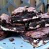 Peppermint patty brownies piled on a plate.