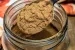 A spoon of pumpkin pie spice over a jar of spice.