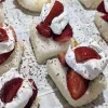 Strawberry shortcake bites on a paper-lined tray.