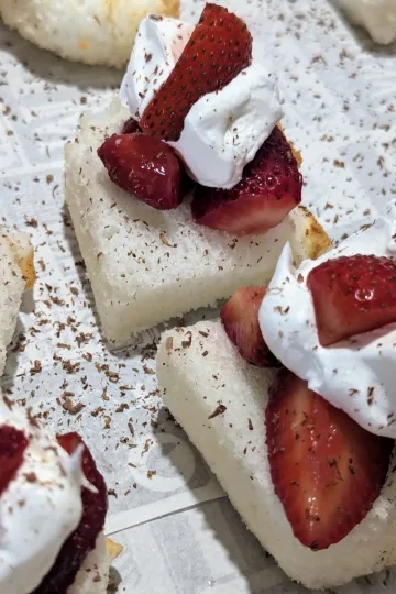 Strawberry shortcake bites on a paper-lined tray.