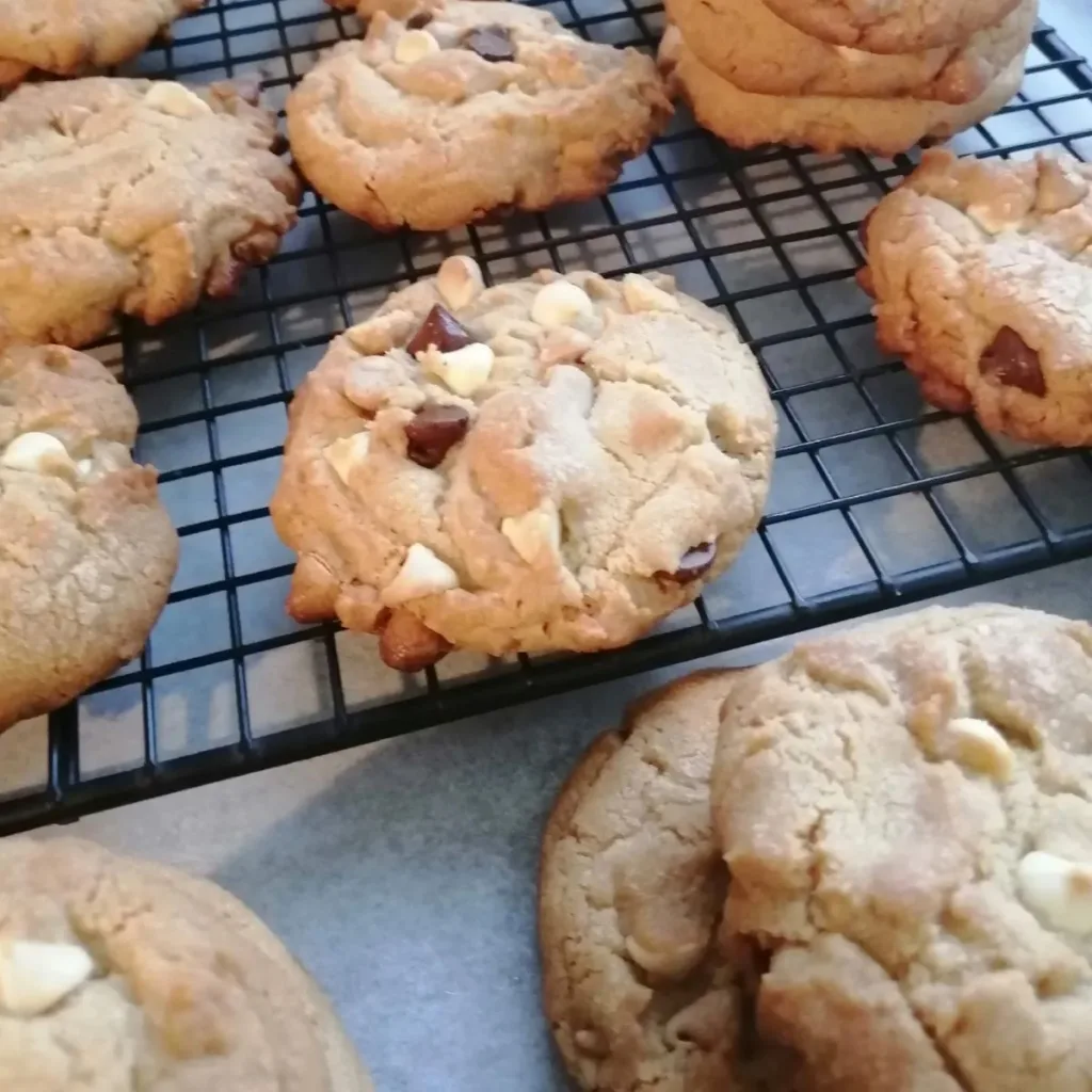 Triple chocolate chip cookies on a cooling rack.