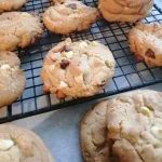 Triple chocolate chip cookies on a cooling rack.