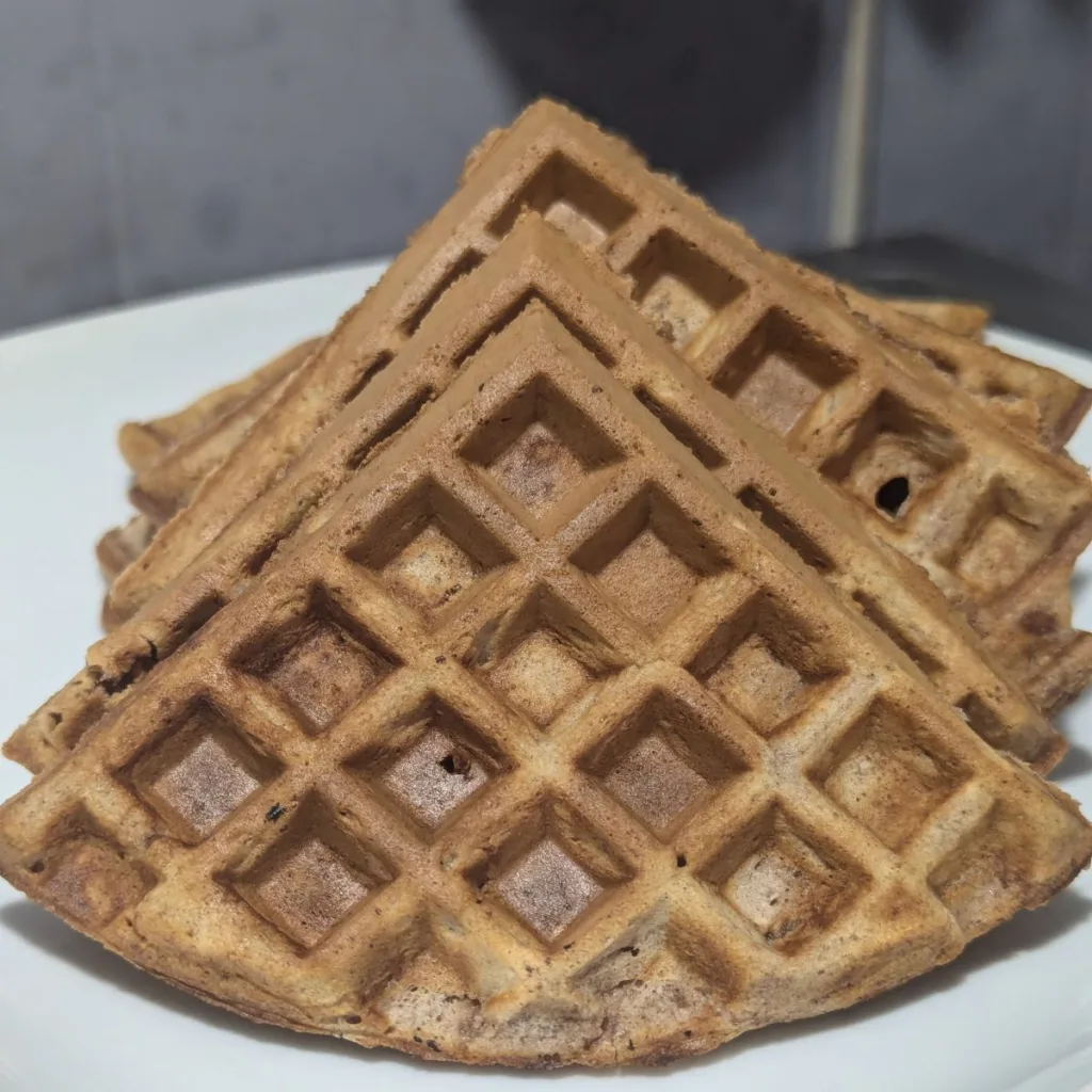 Quartered cinnamon waffles on a plate.