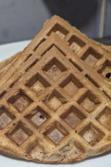 Quartered cinnamon waffles on a plate.