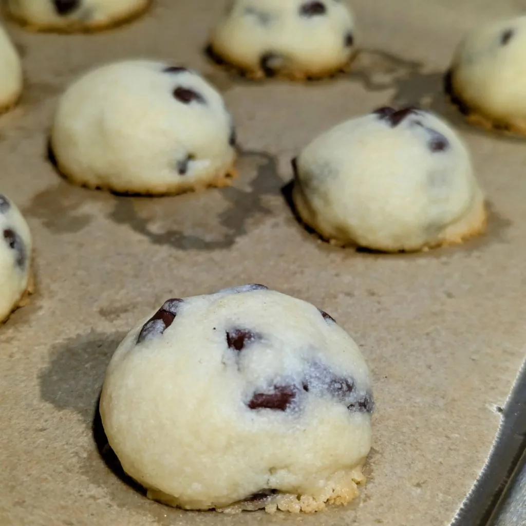 Chocolate chip shortbreads on a parchment lined pan.