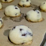 Chocolate chip shortbreads on a parchment lined pan.