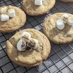 Four S'mores cookies on a wire rack.