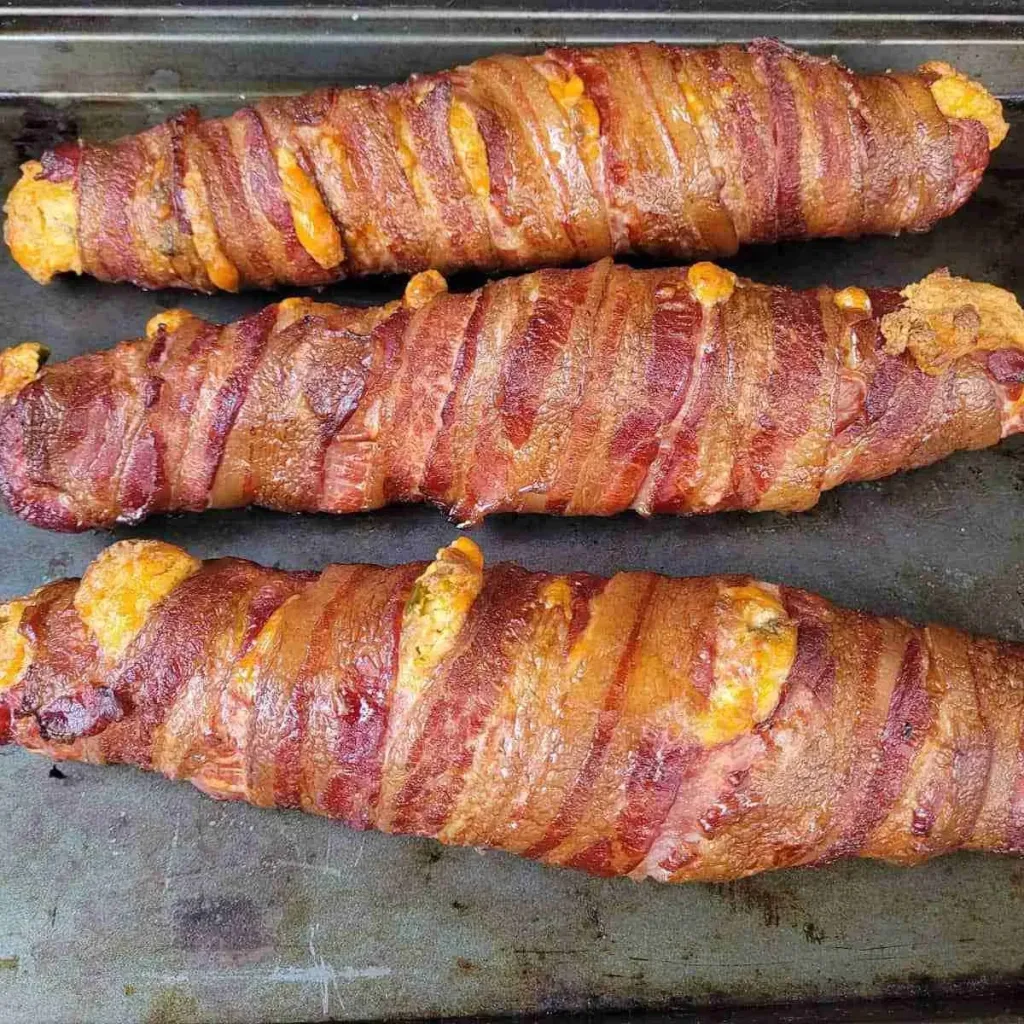 Three Jalapeno Cheddar Stuffed Pork Tenderloins on a tray. 