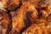 Dry rub chicken wings piled on a plate.
