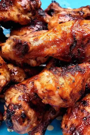 Sticky BBQ Drumsticks piled on a tray.