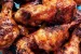 Sticky BBQ Drumsticks piled on a tray.
