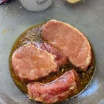 Three pork chops in Honey Ginger Marinade.