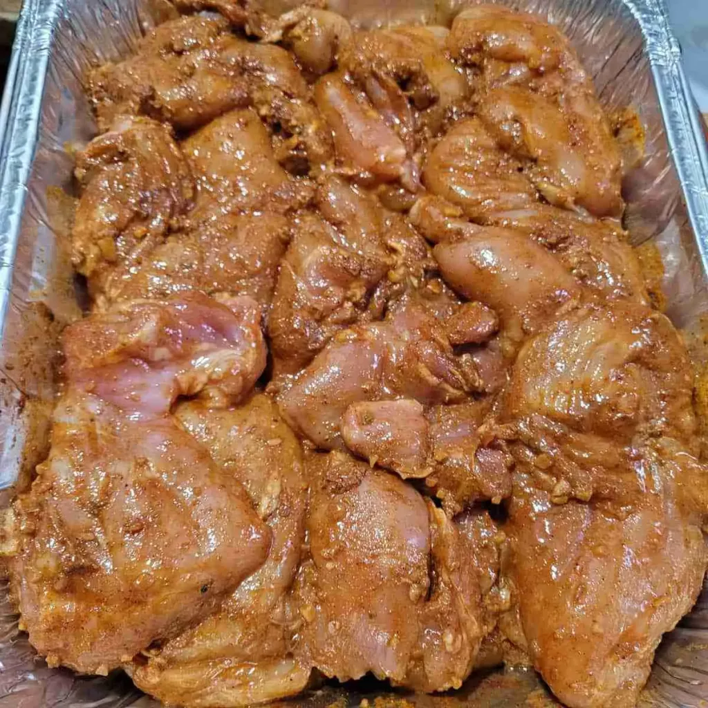A pan of chicken breasts marinating in Southwest chicken marinade.