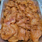 A pan of chicken breasts marinating in Southwest chicken marinade.