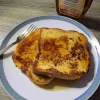 Two slices of easy French toast covered in maple syrup.