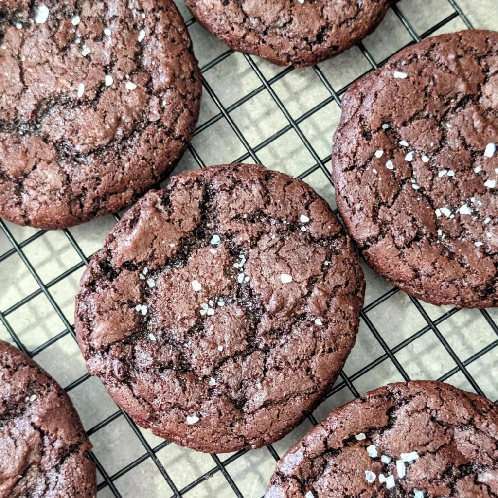Salted Dark Chocolate Cookies on a wire rack.