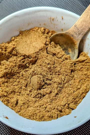 A small bowl of taco seasoning with a spoon in it.