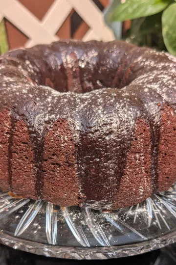 Chocolate mayo bundt cake on a crystal cake platter.