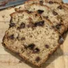 Sliced Chocolate Chip Banana Bread on a wooden cutting board.