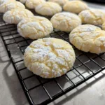 Lemon Crinkle Cookies on a cooling rack.
