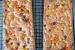 Two Reese's Pieces Cookie Bars on a wire rack.