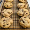Six Eggless Chocolate Chip Cookies on a wire rack.